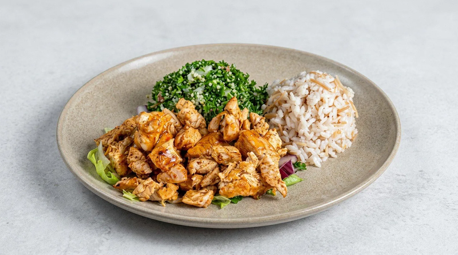 Chicken shawarma platter with rice and tabbouleh at Zaytona Grill