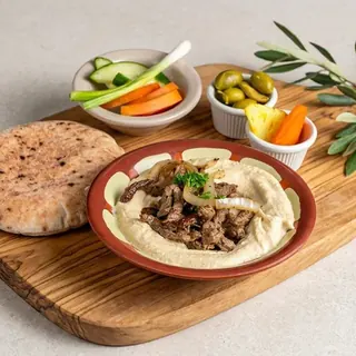 Hummus plate topped with beef shawarma