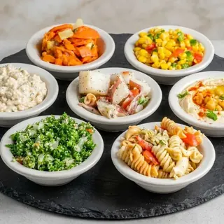 Maza platter with six mezze sides, pita and falafel