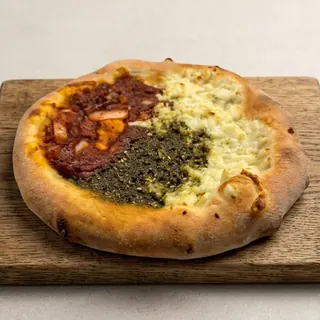Mix manouche with za'atar, cheese and onion in tomato