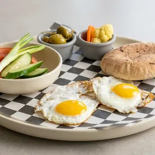 Nazareth Morning breakfast: eggs, hummus, pickles, olives and pita